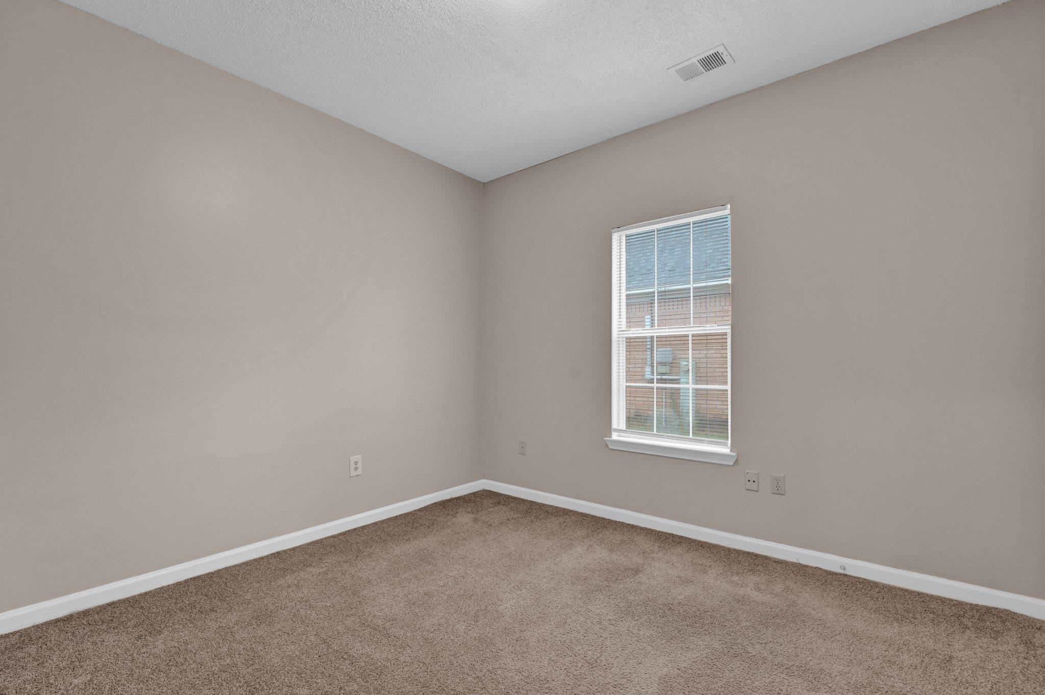 6309 Ragan Farm Drive Memphis, TN 38141 - Photo 18 of 25 Carpeted empty room featuring a textured ceiling