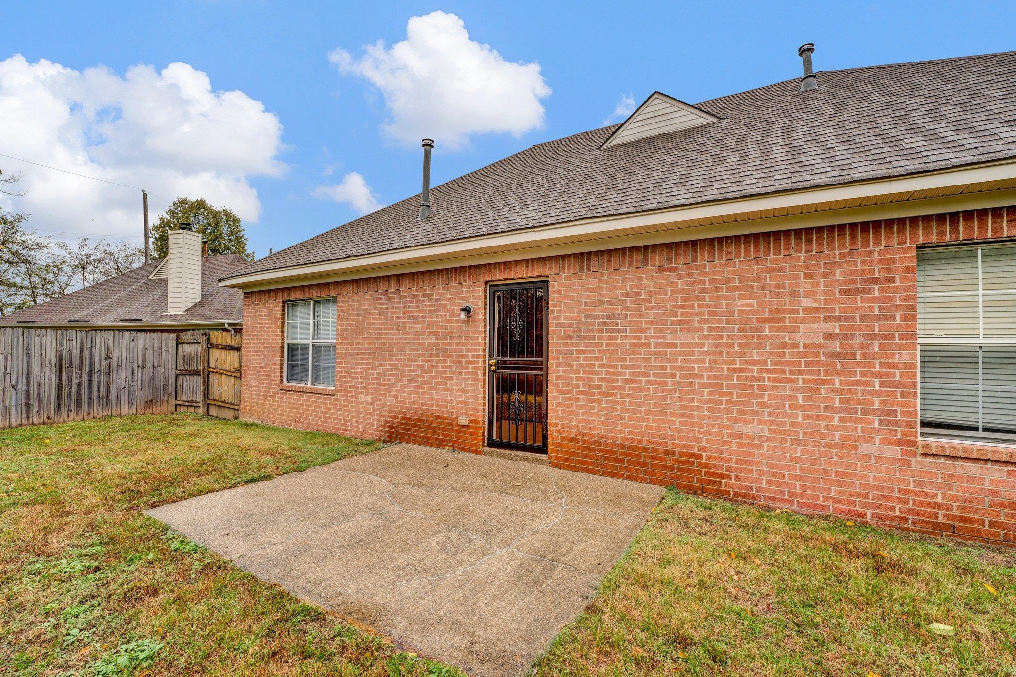 6309 Ragan Farm Drive Memphis, TN 38141 - Photo 21 of 25 Back of property featuring a patio and a yard