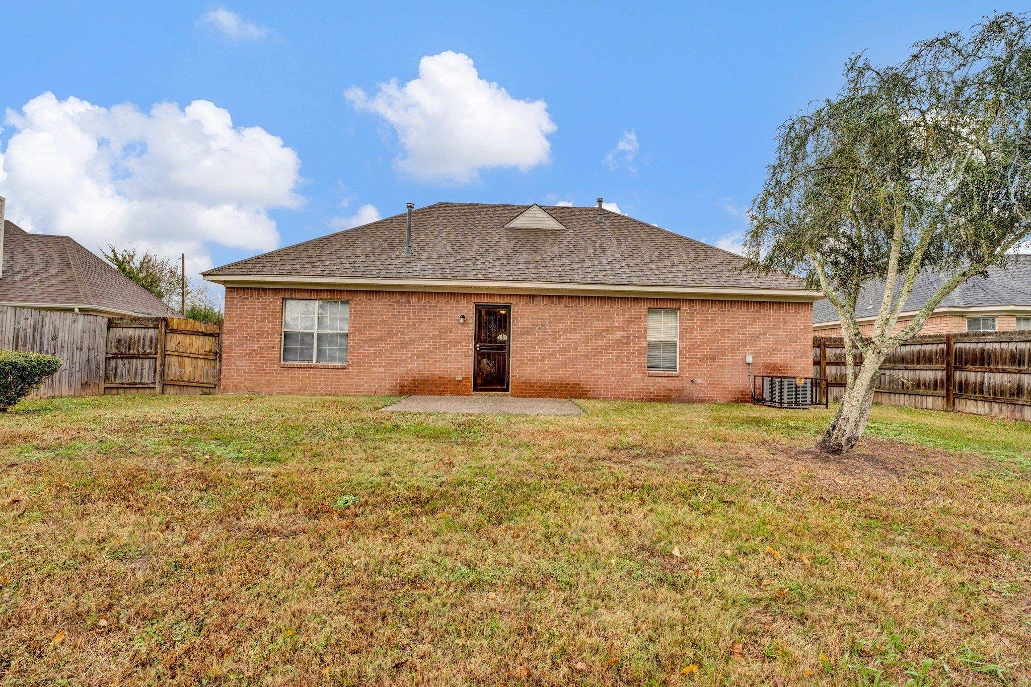 6309 Ragan Farm Drive Memphis, TN 38141 - Photo 24 of 25 Back of property with central AC unit, a patio, and a yard