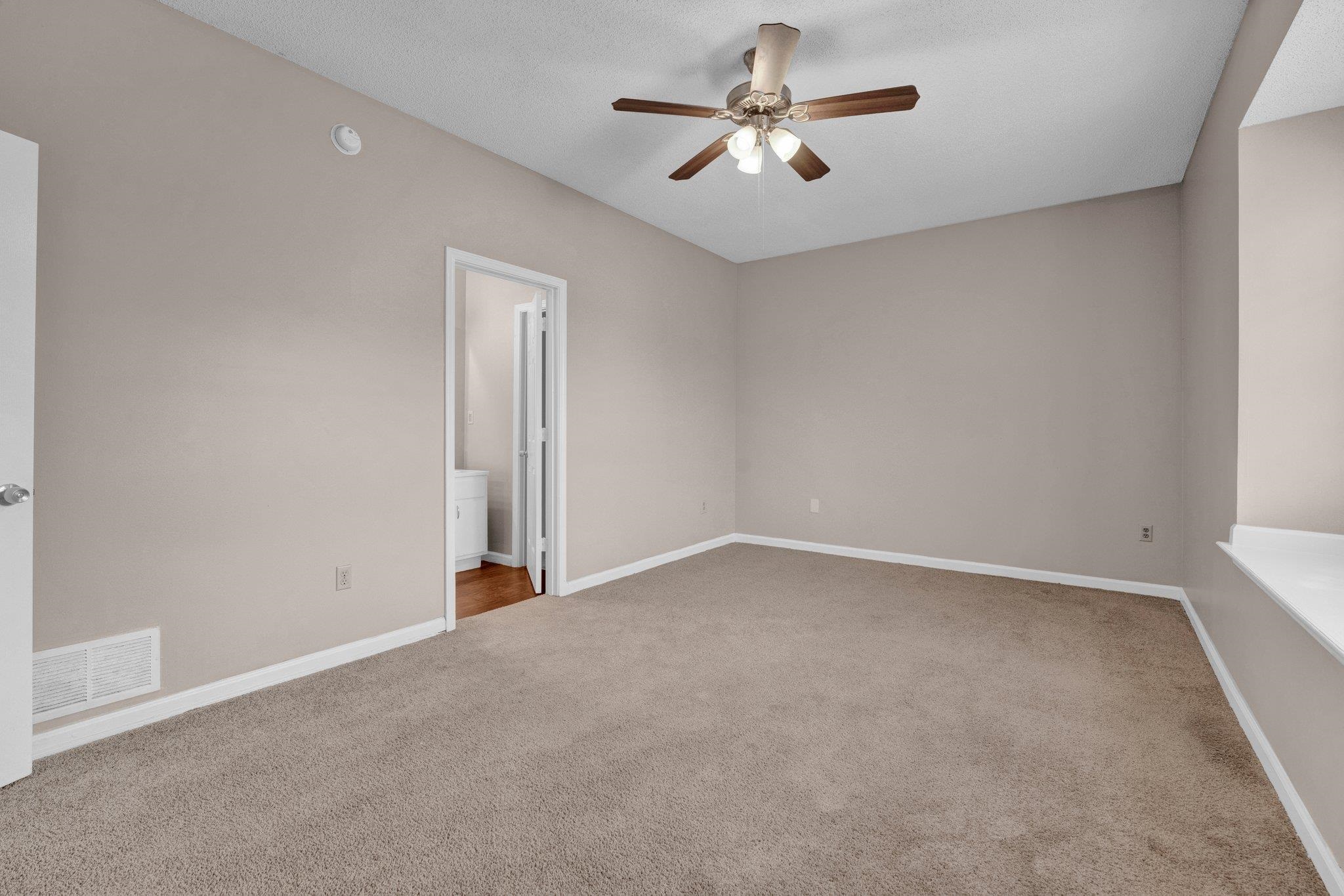 6309 Ragan Farm Drive Memphis, TN 38141 - Photo 3 of 25 Empty room with carpet and ceiling fan