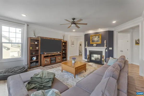 a living room with a bed furniture and a window