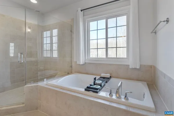 a spacious bathroom with a double vanity sink shower and a mirror