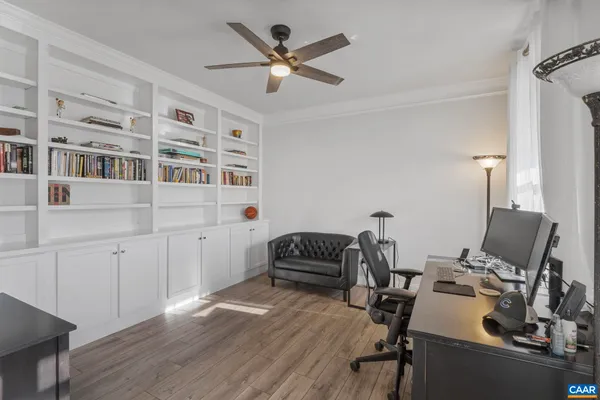 a work room with furniture and wooden floor