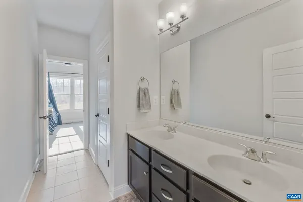 a large kitchen with stainless steel appliances a large counter top a stove and a refrigerator