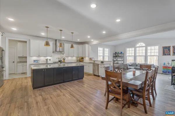 a kitchen with stainless steel appliances granite countertop a sink a stove a refrigerator and a center island
