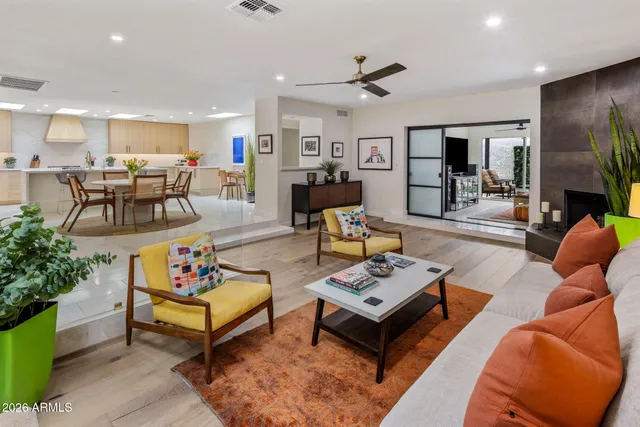 a living room with furniture kitchen view and a table