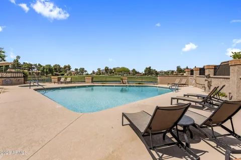 a view of a lake with table and chairs