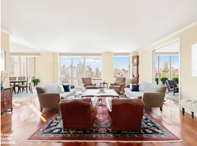 a view of a hallway with wooden floor and a living room