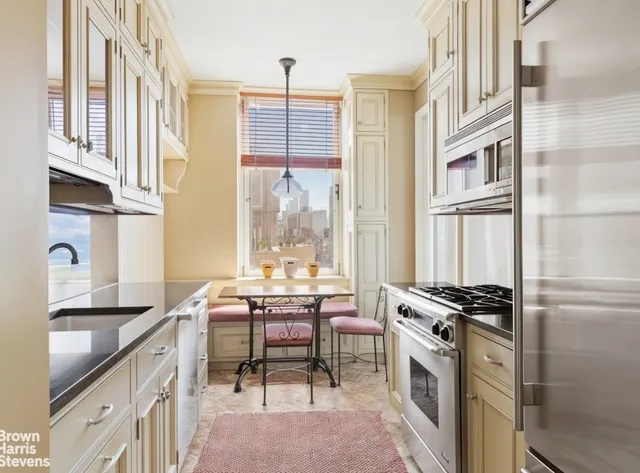 a view of a city view from a roof deck with table and chairs