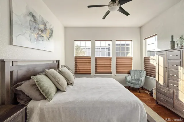 a bedroom with bed and wooden floor