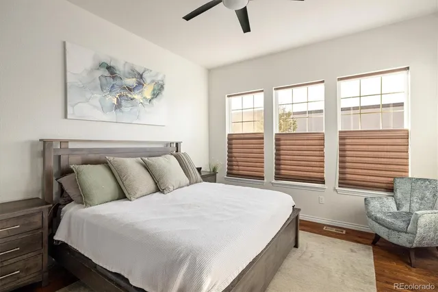 a bedroom with a bed and a painting on the wall