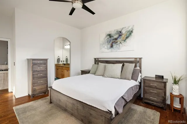 a spacious bedroom with a bed and a chandelier