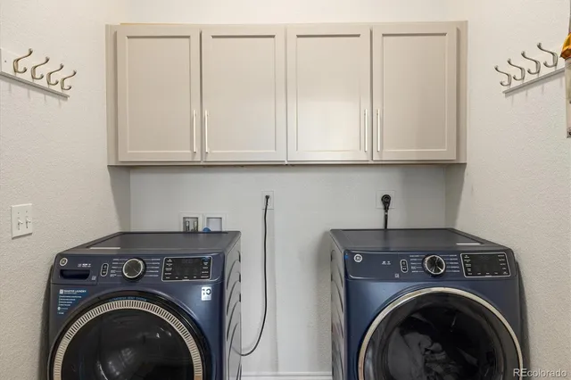 a view of storage and utility room with washer and dryer
