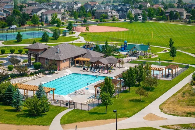 an aerial view of a house with a garden and lake view
