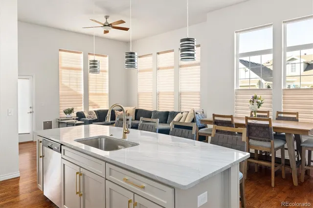 a kitchen with a stove a sink a dining table and chairs