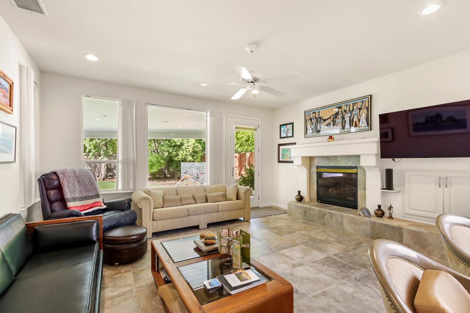 5415 Rogers Street Davis, CA 95618 - Photo 16 of 77 a living room with furniture a fireplace and a flat screen tv