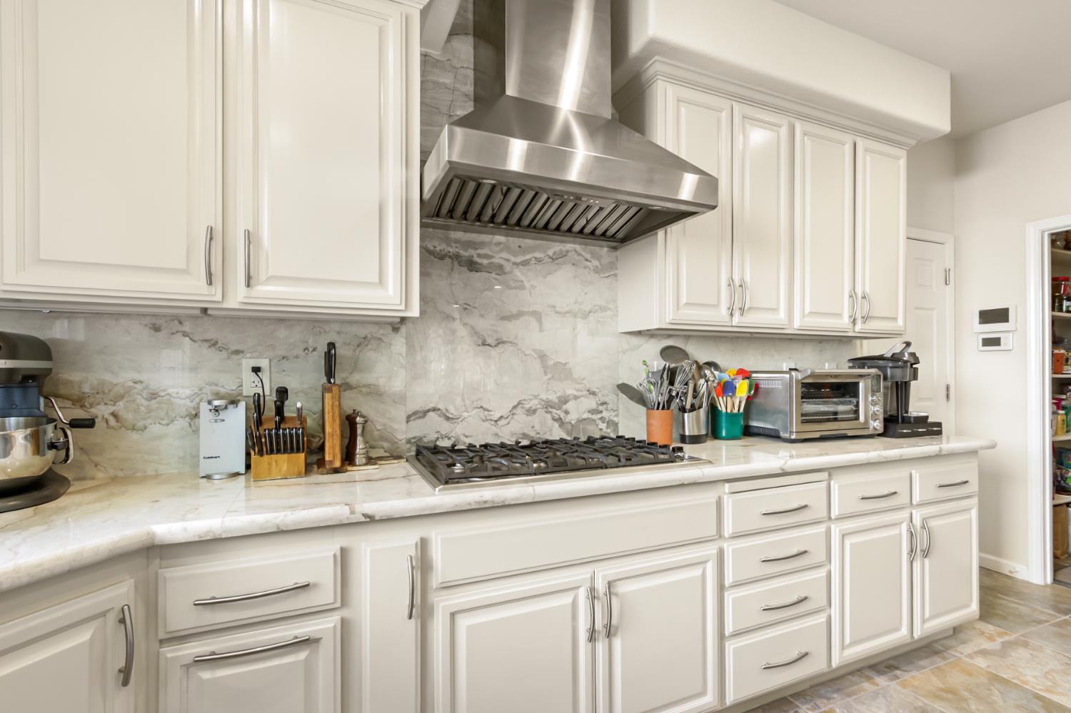 5415 Rogers Street Davis, CA 95618 - Photo 24 of 77 a kitchen with white cabinets and a counter space
