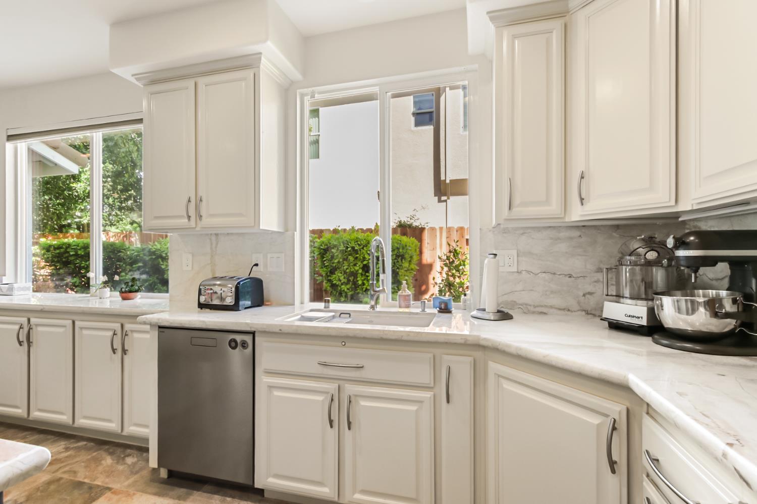 5415 Rogers Street Davis, CA 95618 - Photo 27 of 77 a kitchen with a sink a window and cabinets