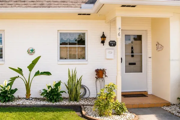 a front view of a house with garden