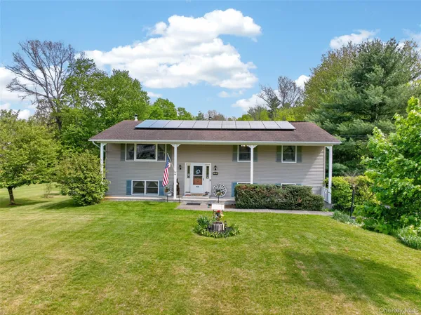 a view of a house with a backyard