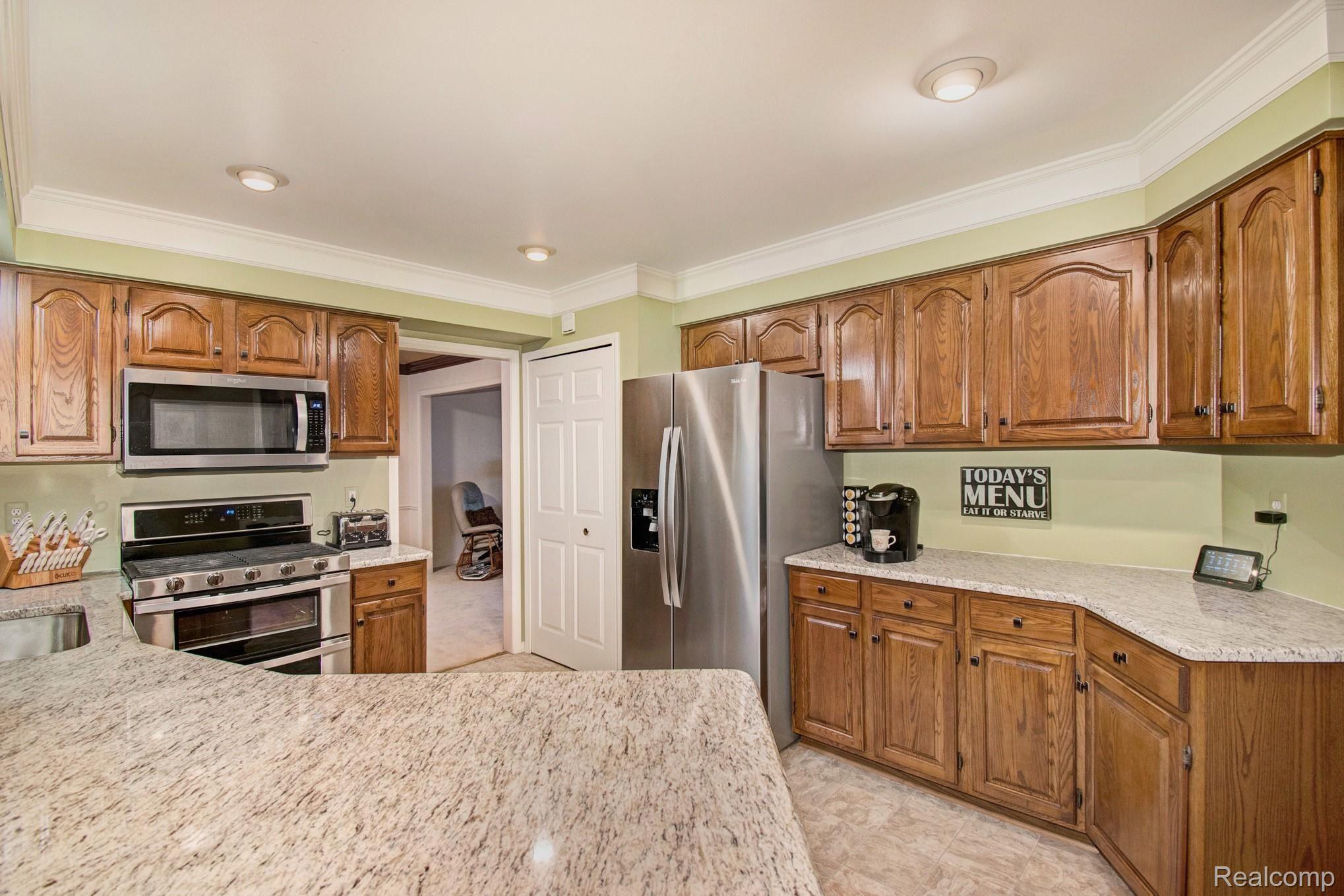 16349 Judiciary Road Macomb, MI 48044 - Photo 5 of 15 This gorgeous kitchen has a fabulous layout, refinished cabinets, new granite countertops, backsplash and stainless steel appliances!