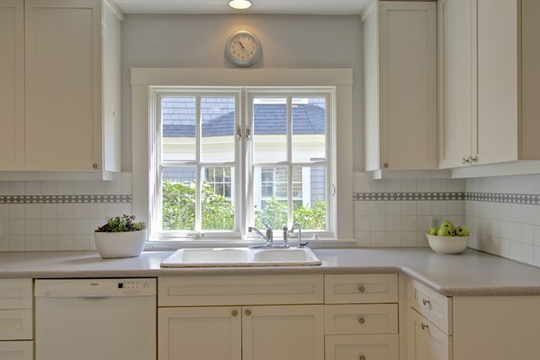 40 Glen Road Winchester, MA 01890 - Photo 15 of 30 a kitchen with stainless steel appliances white cabinets and a potted plant