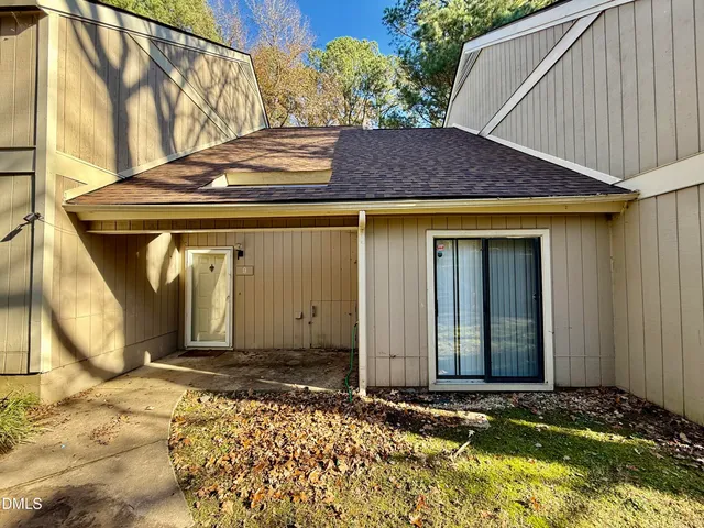 a view of a house with window and wooden fence