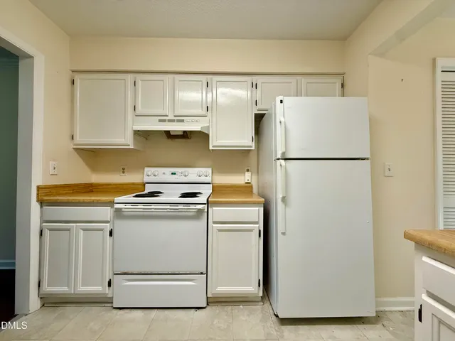 a white refrigerator freezer sitting inside of a kitchen
