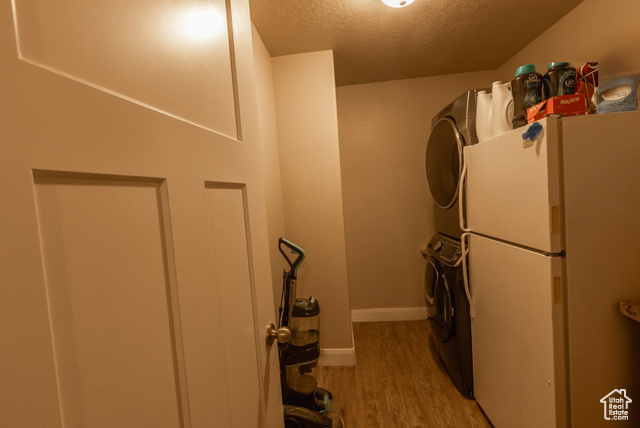 660 East 400 North Spring City, UT 84662 - Photo 7 of 16 Washroom featuring a textured ceiling, light wood finished floors, baseboards, laundry area, and stacked washer and dryer