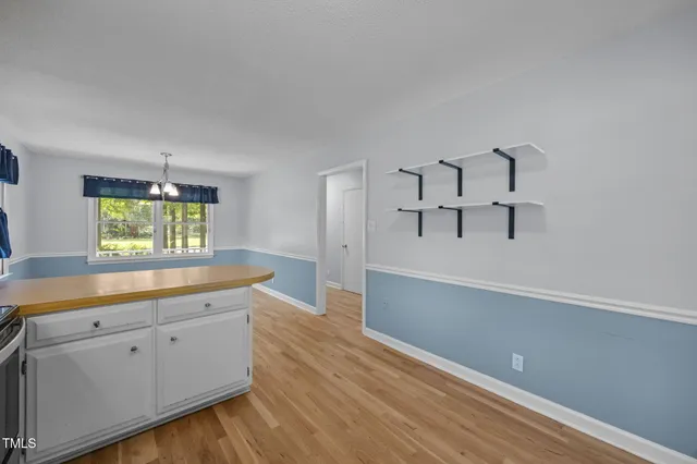 a view of a kitchen with wooden floor