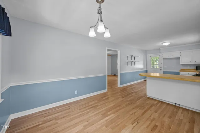 a view of kitchen with wooden floor and window
