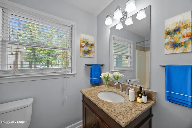 a dining room with furniture and a window