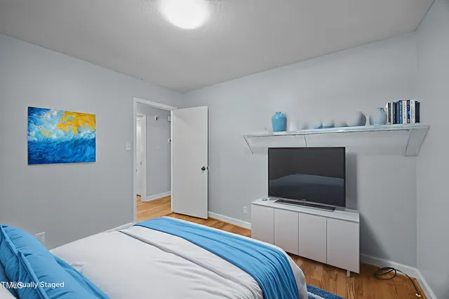 a bedroom with a bed and a television