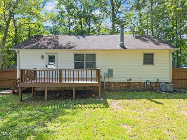 a view of a house with a yard and furniture
