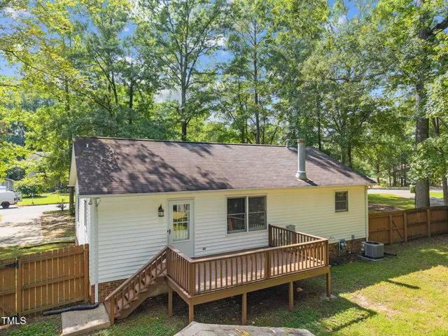 a view of a house with a roof deck and chair
