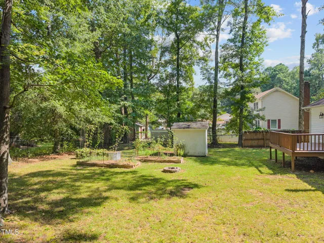 a backyard of a house with table and chairs