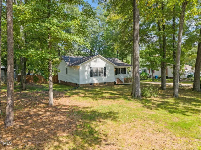 a house view with swimming pool in front of it