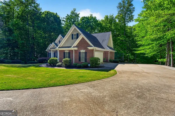 a view of a dining room with furniture a chandelier and wooden floor