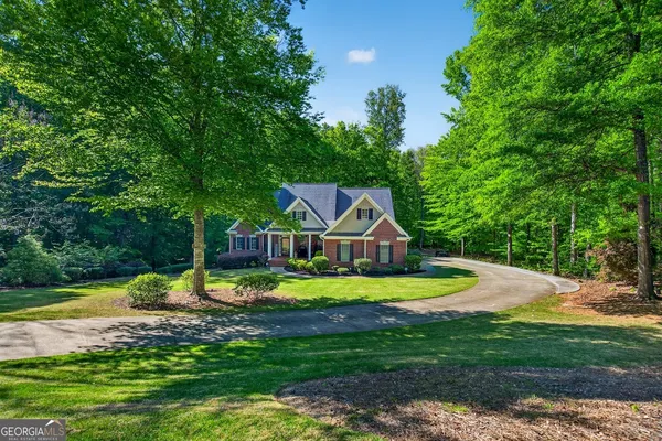 a living room with furniture a fireplace and a chandelier
