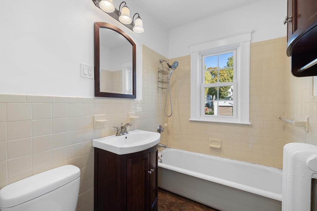 19 Alabama Street, Unit 1 Boston, MA 02126 - Photo 11 of 16 a bathroom with a sink a toilet and bathtub