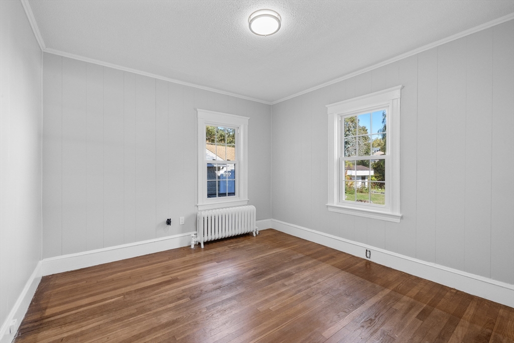 19 Alabama Street, Unit 1 Boston, MA 02126 - Photo 12 of 16 an empty room with wooden floor and windows