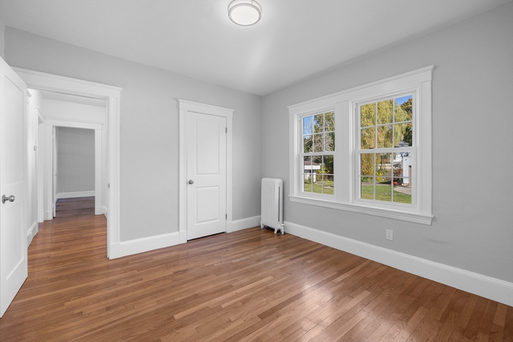19 Alabama Street, Unit 1 Boston, MA 02126 - Photo 13 of 16 a view of an empty room with wooden floor and a window