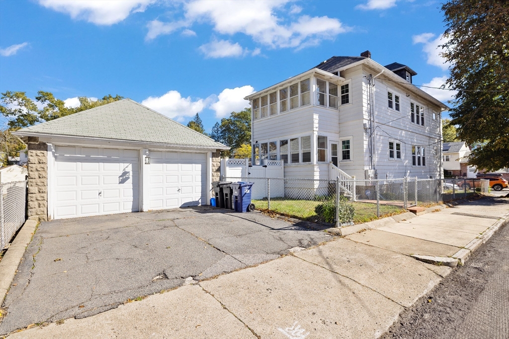 19 Alabama Street, Unit 1 Boston, MA 02126 - Photo 16 of 16 a view of a white house with a yard and sitting area