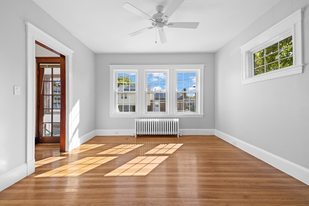 19 Alabama Street, Unit 1 Boston, MA 02126 - Photo 6 of 16 a view of an empty room with a window and wooden floor