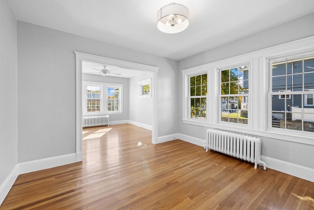 19 Alabama Street, Unit 1 Boston, MA 02126 - Photo 8 of 16 an empty room with wooden floor and windows