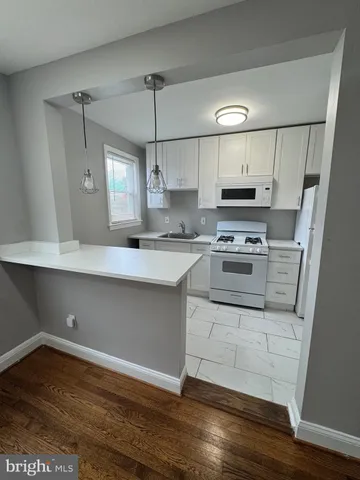 a kitchen with stainless steel appliances a stove a sink and a refrigerator