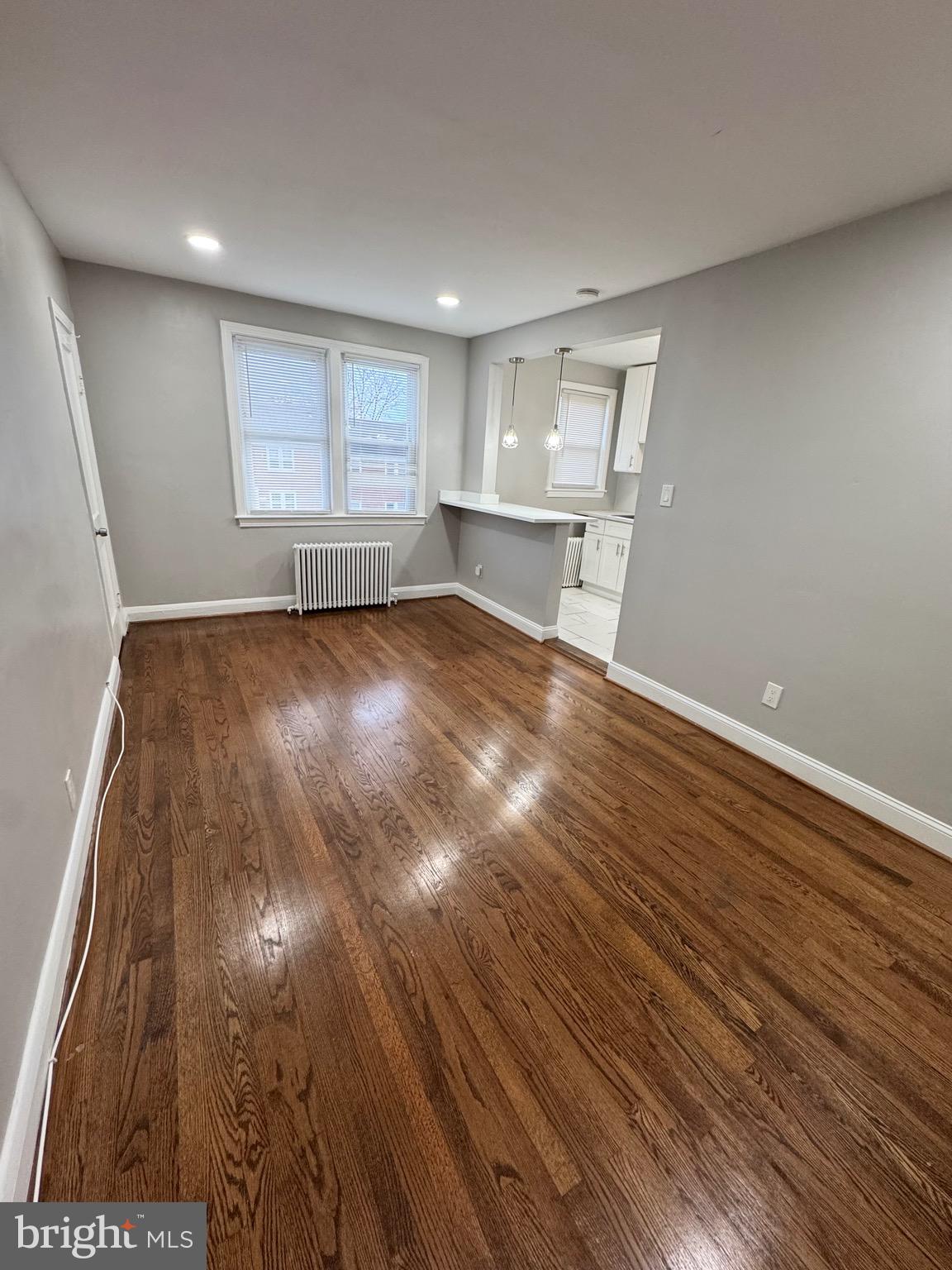 1104 Meridene Drive, Unit 1 Baltimore, MD 21239 - Photo 4 of 7 a view of empty room with wooden floor and fan