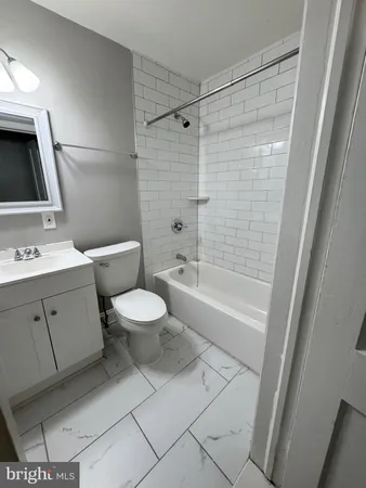 a bathroom with a toilet sink and shower