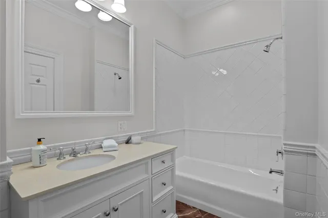 a bathroom with a bathtub vanity sink and mirror