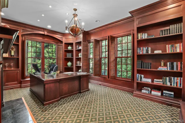 a living room with furniture a bookshelf and a book shelf